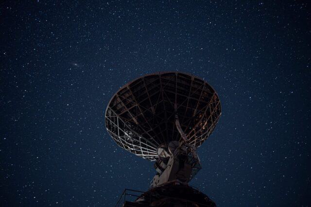 A Picture of A Satellite Pointing Towards the Night Sky. Depiction of Global Communication and Connection