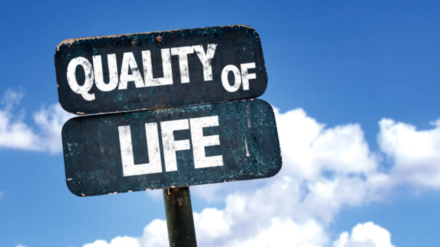 Quality of Life sign with sky background